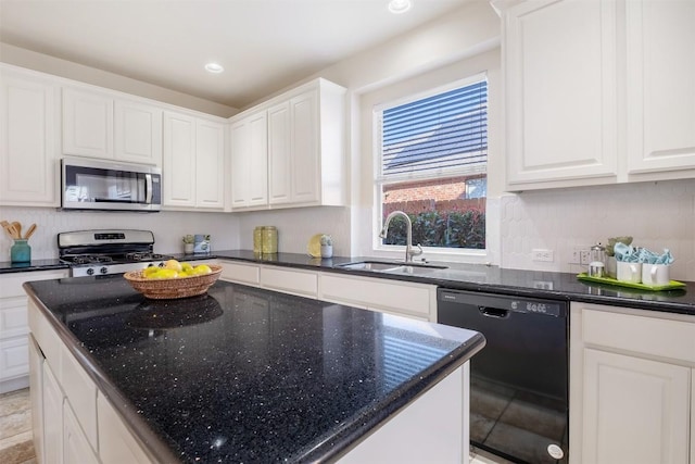 kitchen with a sink, white cabinets, a center island, and stainless steel appliances