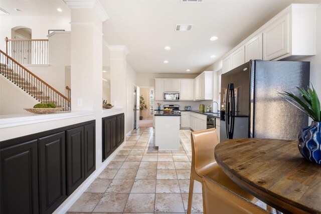 kitchen with visible vents, recessed lighting, white cabinetry, and black appliances