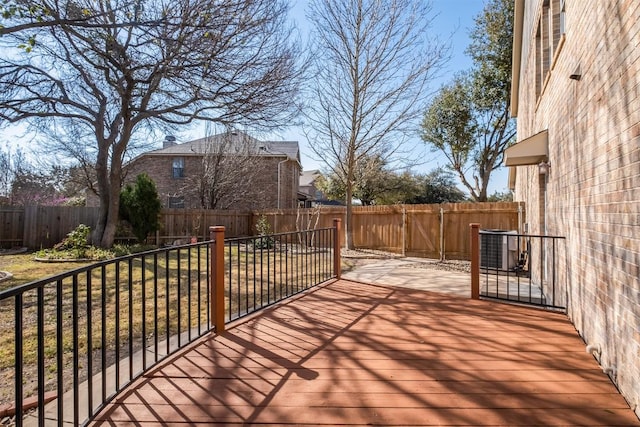 deck with cooling unit and a fenced backyard