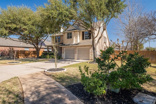 traditional home with an attached garage, driveway, and fence