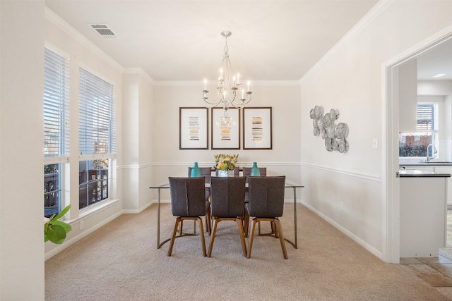 dining space with visible vents, crown molding, and an inviting chandelier