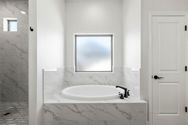 full bathroom with a bath and a marble finish shower