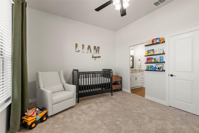 bedroom featuring visible vents, light carpet, ensuite bathroom, a nursery area, and baseboards