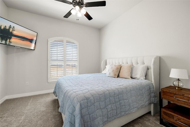 carpeted bedroom with a ceiling fan and baseboards