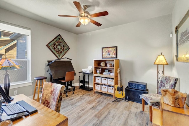 home office with wood finished floors and ceiling fan