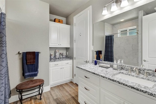 full bathroom featuring curtained shower, wood finished floors, and vanity