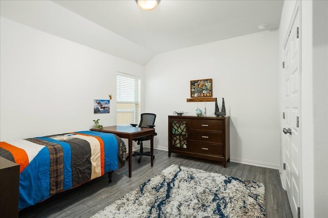 bedroom featuring baseboards, lofted ceiling, and wood finished floors