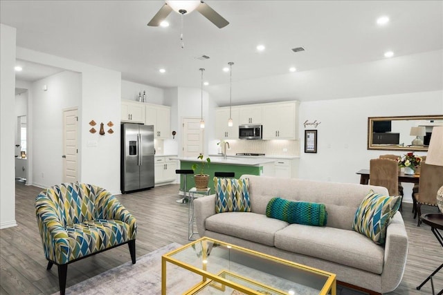 living area featuring visible vents, recessed lighting, a ceiling fan, and wood finished floors