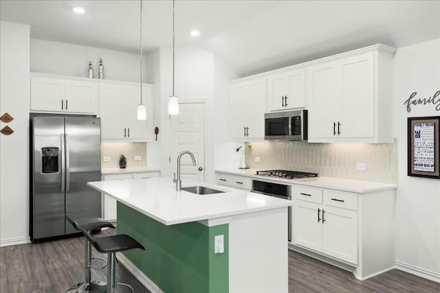 kitchen with white cabinetry, stainless steel appliances, and a sink