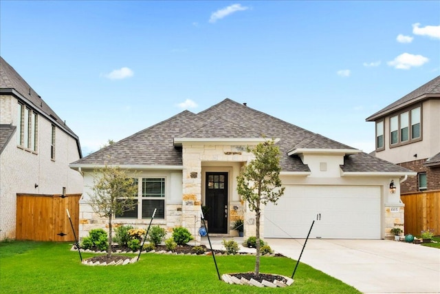 view of front facade featuring concrete driveway, fence, stone siding, and roof with shingles