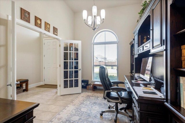 office area featuring baseboards, a chandelier, light tile patterned floors, french doors, and a towering ceiling