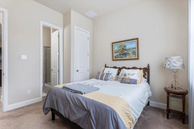 carpeted bedroom with baseboards and ensuite bathroom