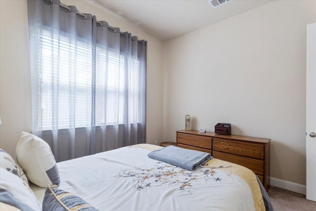 bedroom featuring carpet and baseboards