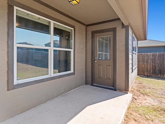 doorway to property featuring fence