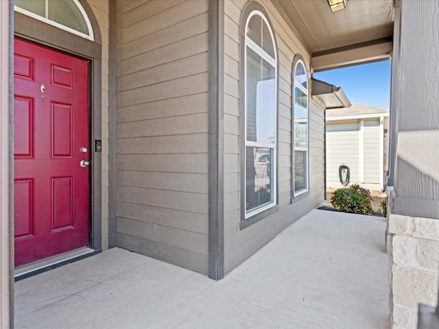 view of exterior entry with covered porch