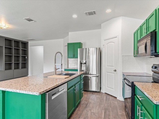 kitchen with green cabinets, black appliances, visible vents, and a sink