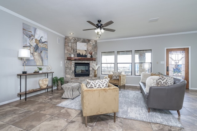 living area with a stone fireplace, a ceiling fan, crown molding, and baseboards