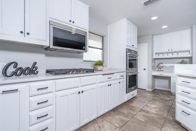 kitchen with visible vents, white cabinets, appliances with stainless steel finishes, and light countertops