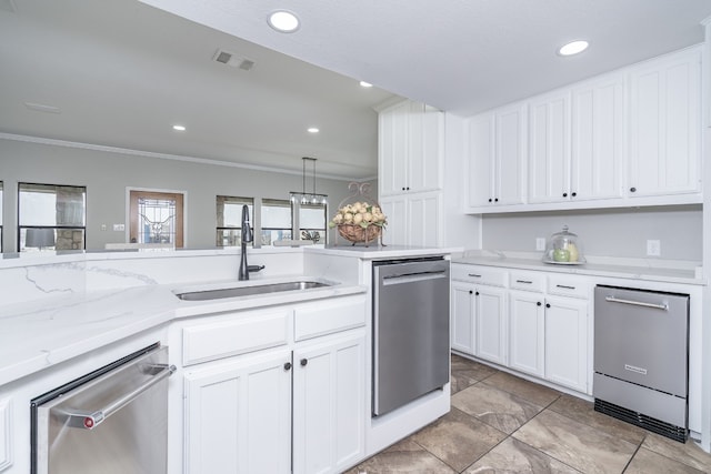 kitchen with dishwasher, visible vents, and a sink