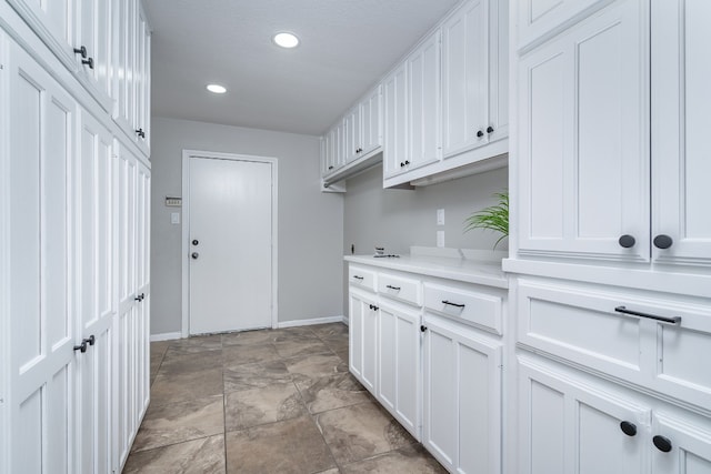 washroom featuring recessed lighting and baseboards