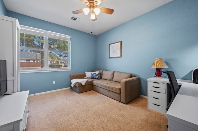 living room featuring visible vents, baseboards, light carpet, and ceiling fan