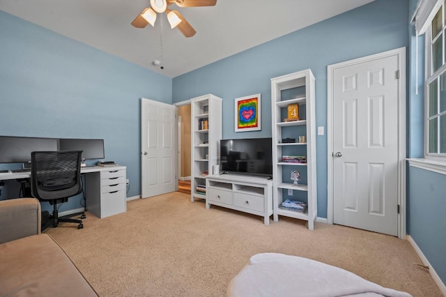 office with ceiling fan, baseboards, and light carpet