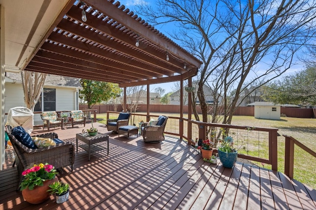 deck featuring a storage unit, a pergola, a fenced backyard, an outdoor structure, and outdoor lounge area