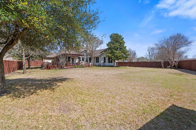 view of yard featuring a wooden deck and a fenced backyard