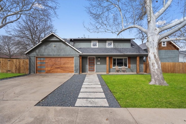 view of front facade featuring a front lawn, fence, brick siding, and driveway