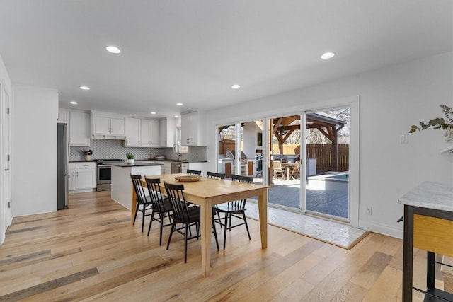 dining area with recessed lighting, baseboards, and light wood-style floors