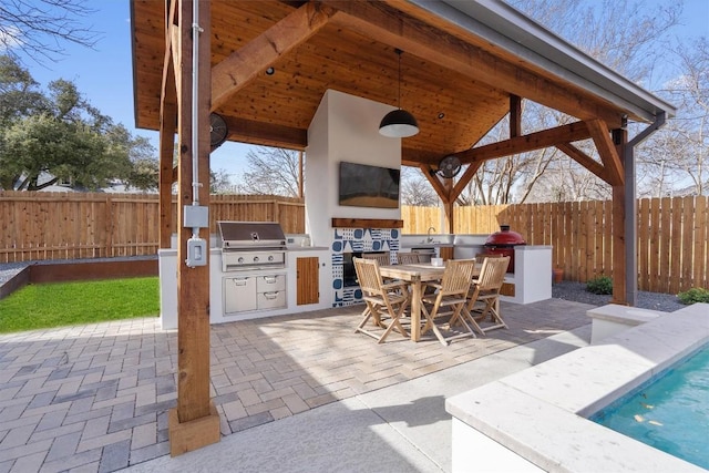 view of patio / terrace with area for grilling, outdoor dining area, a fenced backyard, and a grill