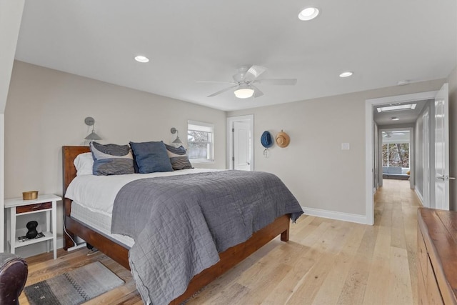 bedroom featuring recessed lighting, multiple windows, light wood-style floors, and baseboards