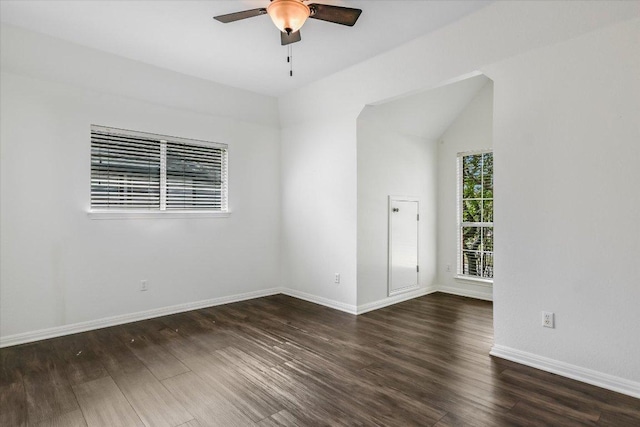 empty room featuring dark wood-style floors, baseboards, and a ceiling fan