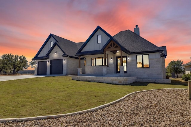 modern farmhouse with board and batten siding, a shingled roof, concrete driveway, a lawn, and a garage