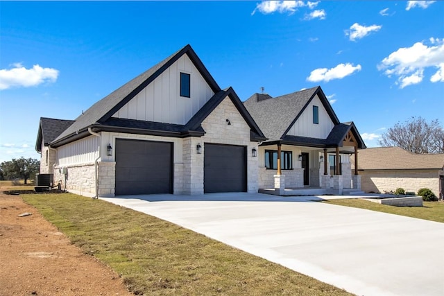 modern farmhouse style home featuring stone siding, board and batten siding, and concrete driveway