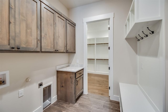 laundry area featuring cabinet space, hookup for an electric dryer, washer hookup, and wood finished floors