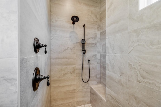 bathroom with a tile shower