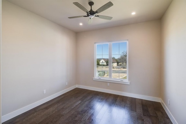 spare room featuring recessed lighting, baseboards, a ceiling fan, and dark wood-style flooring