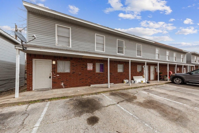 view of property featuring uncovered parking