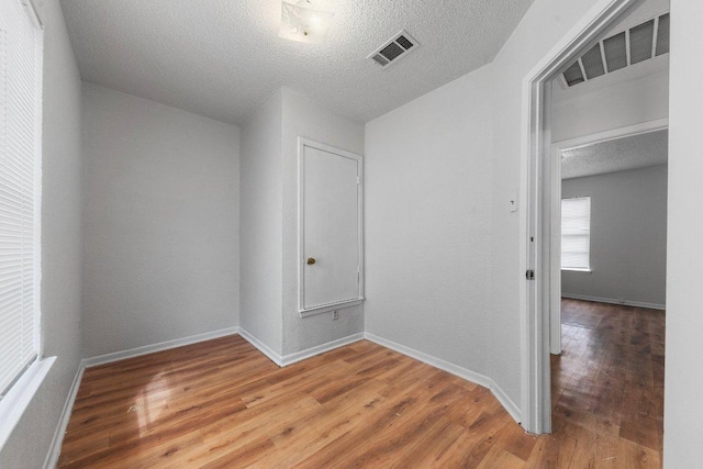 unfurnished room with visible vents, baseboards, and light wood-style floors