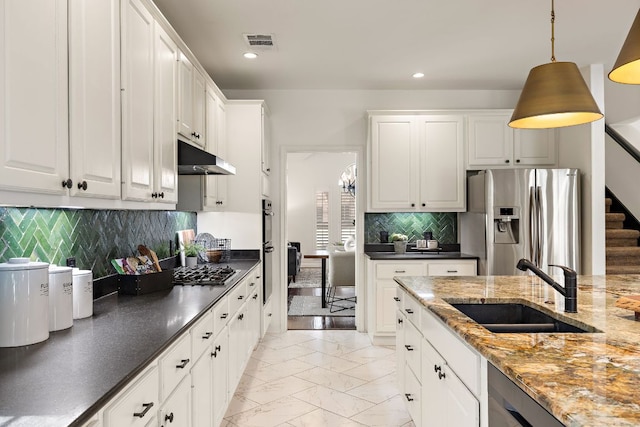 kitchen featuring visible vents, a sink, stainless steel appliances, under cabinet range hood, and marble finish floor