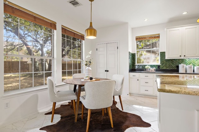 dining space with recessed lighting, visible vents, marble finish floor, and baseboards