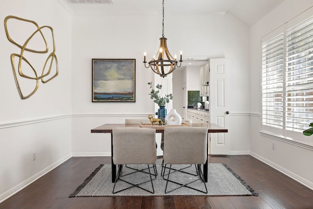 dining space with dark wood finished floors, an inviting chandelier, and baseboards