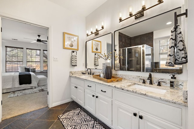 bathroom with a sink, connected bathroom, a stall shower, and double vanity