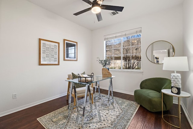 home office with visible vents, ceiling fan, baseboards, and wood finished floors