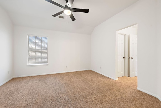 empty room featuring visible vents, light carpet, a ceiling fan, baseboards, and vaulted ceiling