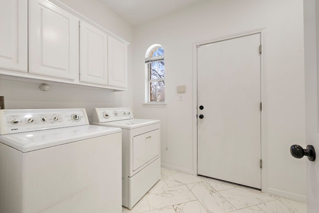 washroom with baseboards, cabinet space, marble finish floor, and washing machine and clothes dryer