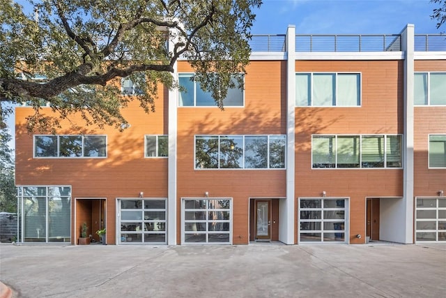 view of property featuring an attached garage and driveway