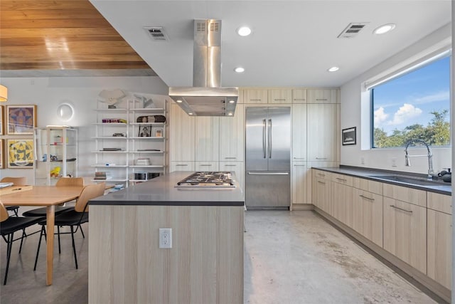 kitchen featuring visible vents, appliances with stainless steel finishes, island range hood, modern cabinets, and a sink