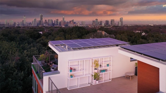 2301 S 5th St Unit 25, Austin, TX 78704 - back of house at dusk featuring stucco siding and a view of skyline